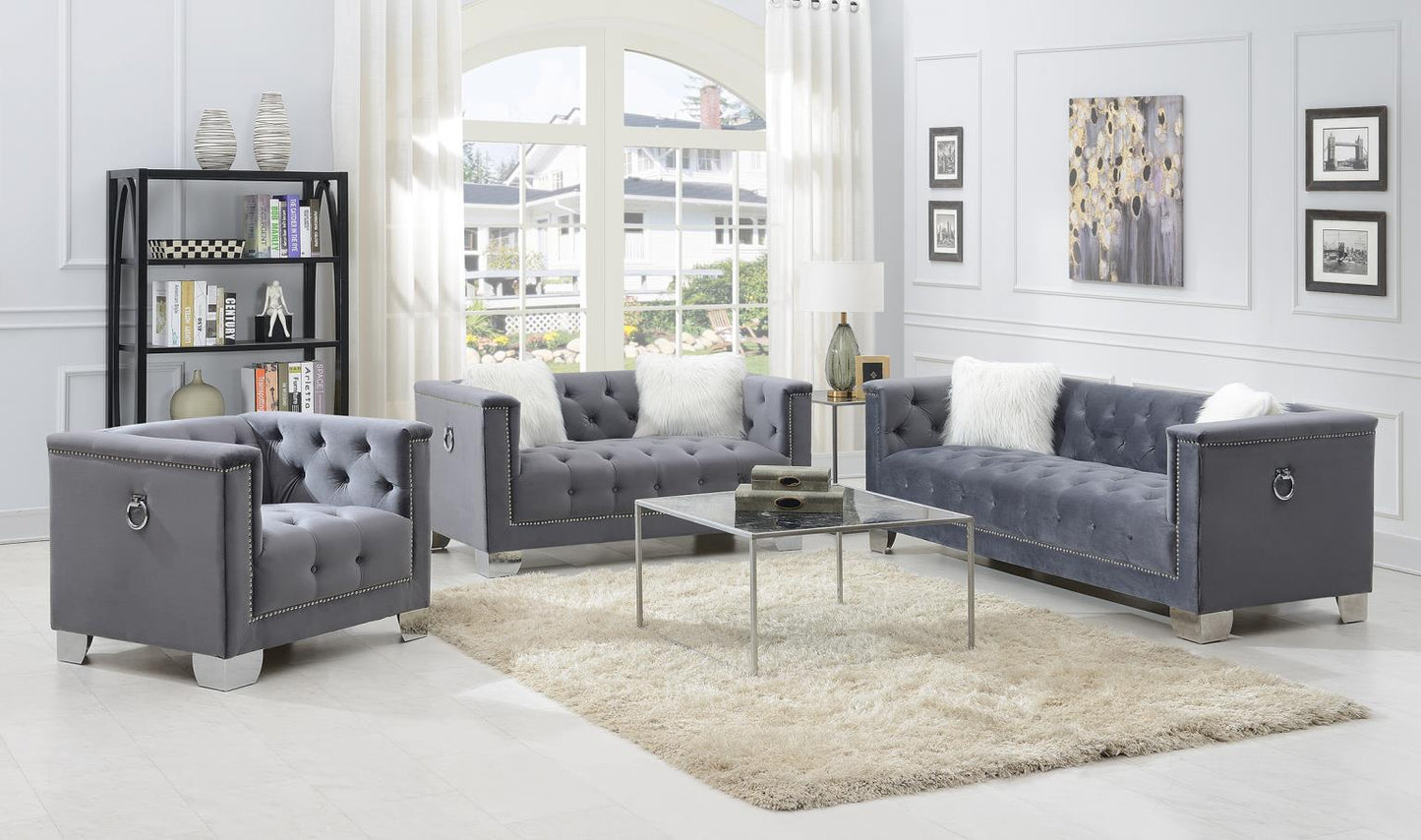 GRAY SOFA W/TWO WHITE FUR PILLOWS